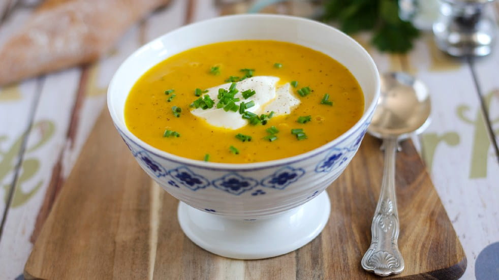 bowl of vegetable soup topped with creme fraiche